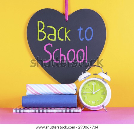 Back to School or Education Concept with clock, books and heart shape blackboard with sample text.