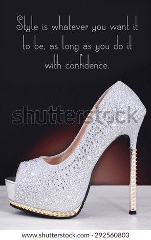 High heel silver with rhinestone stiletto shoe with Style is Whatever You Want quote, on white wood table and black background.