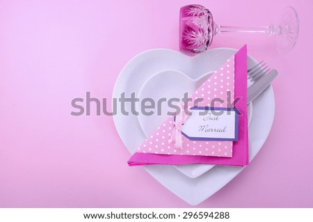 Modern Wedding Table Place Setting with Heart Shape Plates on Pink Table Background.