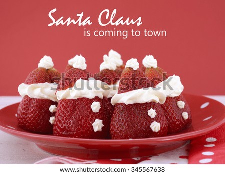 Strawberry Santas on red and white polka plate on red and white background for fun, cute Christmas festive party food.