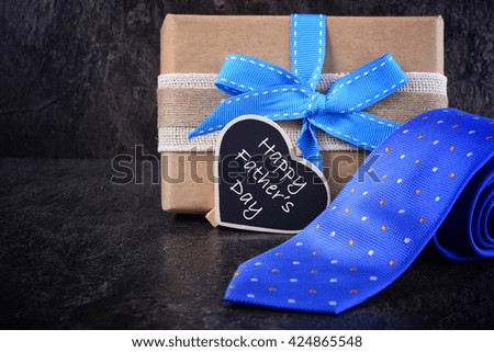 Happy Fathers Day gift on black slate background.