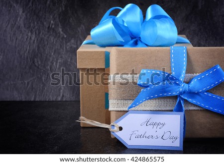 Happy Fathers Day gift on black slate background.
