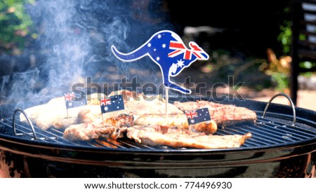Iconic Australian BBQ close up of man cooking chops, sausgaes and steak, outdoors in garden setting.