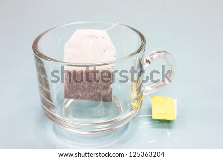 tea bag in cup on glass table
