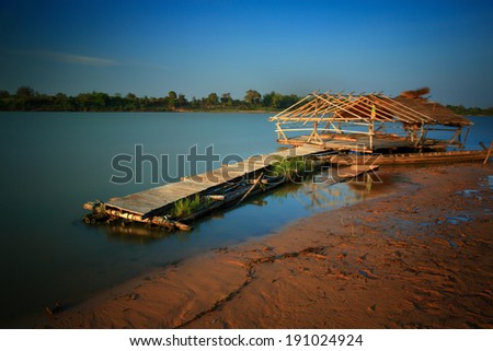Houseboat on the Moon River in Thailand after sunset.