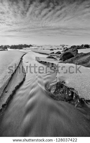 River mouth on the sea, black and white beach scene with nice light