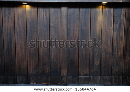 Twin ray light on antique wooden wall