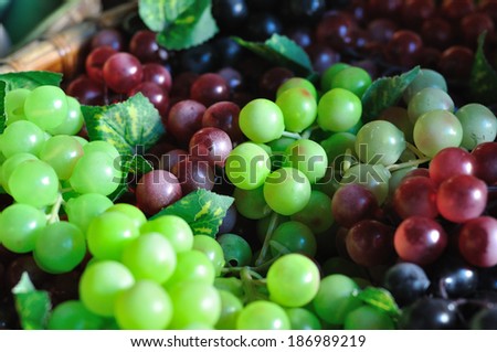 Many huddle color grapes fruit, green, red and black.