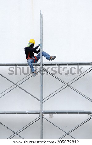 BANGKOK-July 14: Unidentified workers setting up iron scaffolding at construction area on July 14, 2014 Bangkok, Thailand.