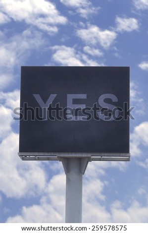 Yes word in billboard with blue sky, positive thinking.