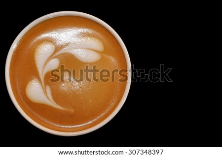 Cup of latte art with hearts from cream on black background with clipping path