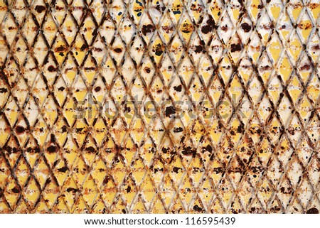 Abstract background of an old rusty iron trellis with geometric diamond patterns formed by diagonal lines of metal