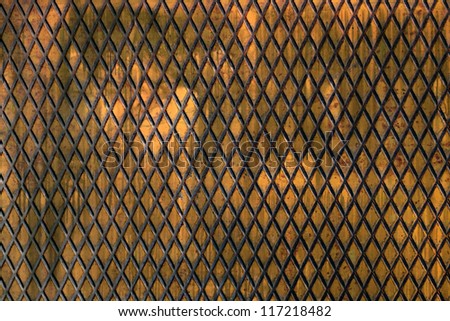 Abstract background of a metal trellis with a repeat diamond pattern formed by intersecting diagonal lines