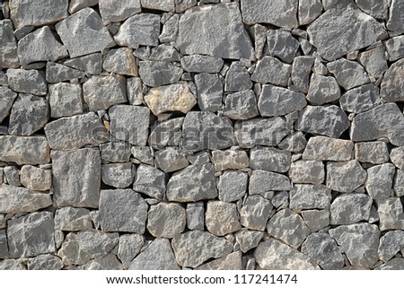 Rough stones in a dry-stone construction where stones are carefully fitted into each other by shape without the use of cement