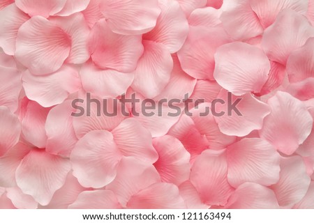 Background texture of beautiful delicate pink rose petals in a random pile