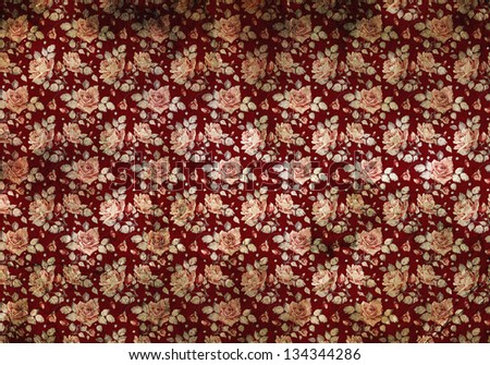 Background floral texture with a retro burgundy wallpaper with pink roses and flowers in a cluttered repeat pattern
