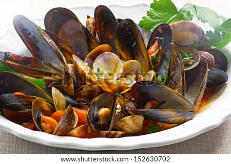 Close-up view of nicely decorated Mussels and Clams on a plate.