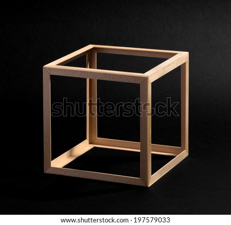 Open frame wooden cube with equilateral sides on a black background