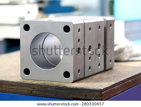 Newly machined industrial components standing on a workbench in a mechanical engineering workshop