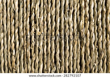 Background of natural hemp fibers loosely twisted into strands and braided then laid parallel for matting