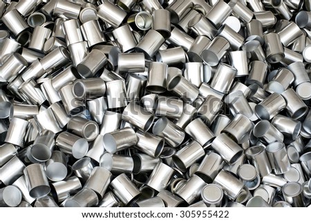 Background texture of empty silver unlabelled aluminium cans for packaging and food preservation, full frame overhead view