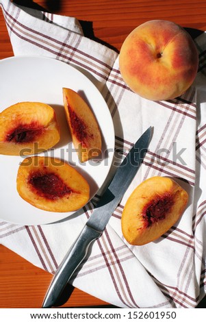 Sliced fresh peaches on plate
