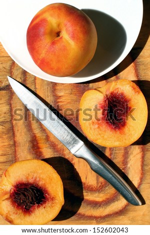 Sliced fresh peaches with knife