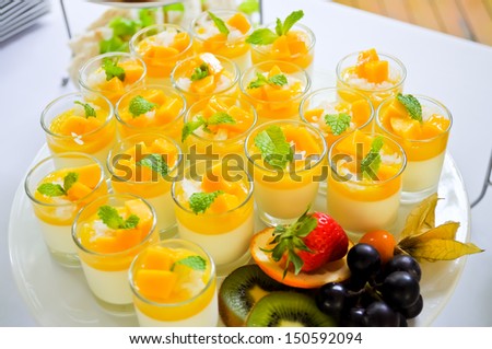 Thai traditional dessert, Mango with sticky rice and coconut milk serve in small glass.