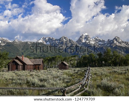 The Chapel of the Transfiguration set against the snow capped peaks of Grand Teton National Park in summer