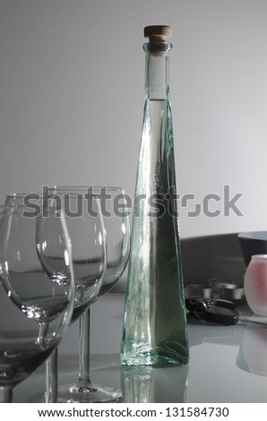liquor bottle with glasses and miscellaneous object on bar stand