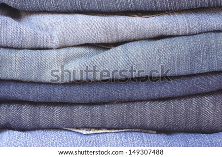 close up of a stack of folded jeans horizontally cropped