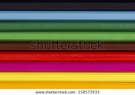 close up of a stack of pencil crayons in many colors creating background