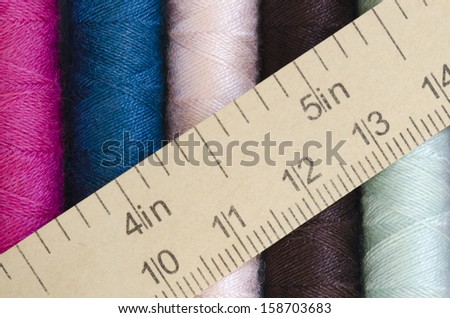sewing thread in many colors with measuring tape texture background