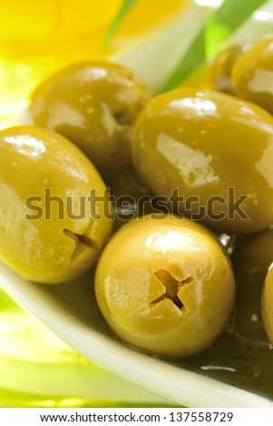 Stuffed green olives and olive oil macro (vertical)