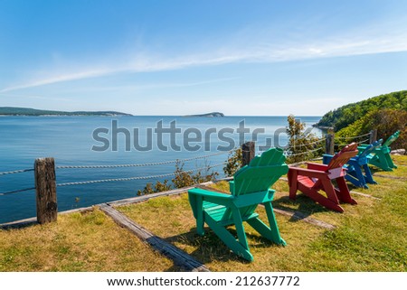 Colorful lounge chairs with a view of beautiful scenic panorama  (Cape Breton Highlands National Park, Canada)
