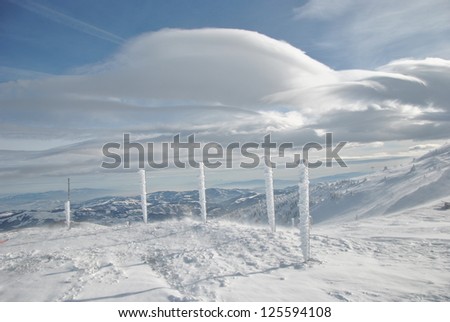 Winter landscape, pillars and cloud Altocumulus lenticuleris, horizontal orientation