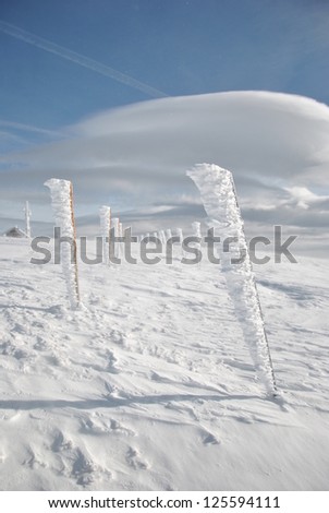 Winter landscape, pillars and cloud Altocumulus lenticuleris, vertical orientation