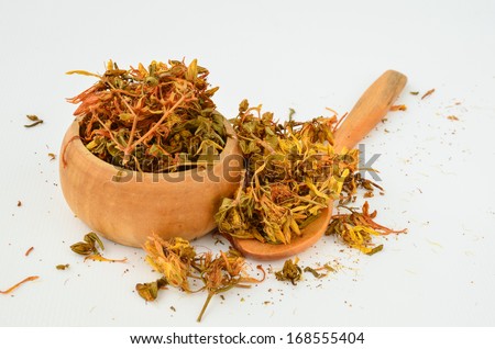 Dry St. John\'s Wort - Hypericum Perforatum in a wooden bowl with teaspoon