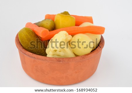 Mixed, pickled vegetables in rustic, clay bowl
