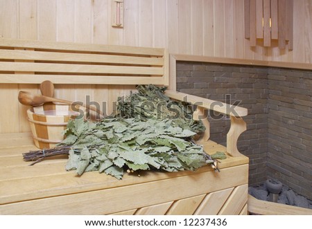 Wooden wash-tub, scoops and oaken besoms in steam bath-room