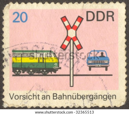 The scanned stamp. German stamp. The car on a railway crossing.