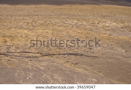Sand in desert. Soil dried up from a heat. Yellow sand.
