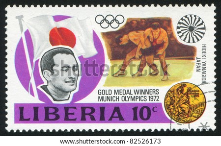 LIBERIA - CIRCA 1973: stamp printed by Liberia, shows Gold medal winners in 20th Olympic Games, Hideaki Yanagida, Japan, wrestling, circa 1973