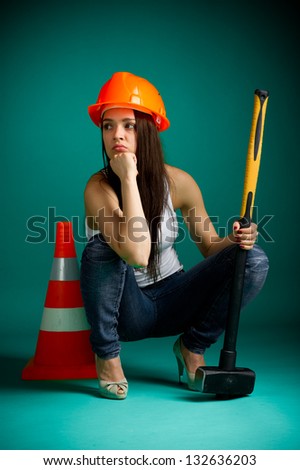 Girl in a helmet with a sledgehammer