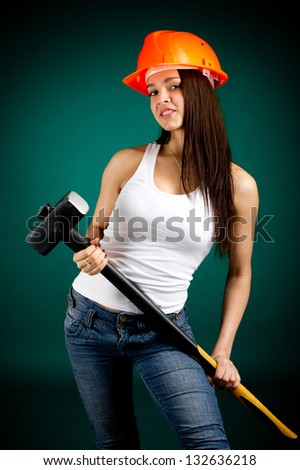 Girl in a helmet with a sledgehammer