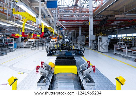 Automotive mechanical assembly, engine, transmission, suspension and breaking system. Automotive engine assembly line is in production. Car Assembly by parts