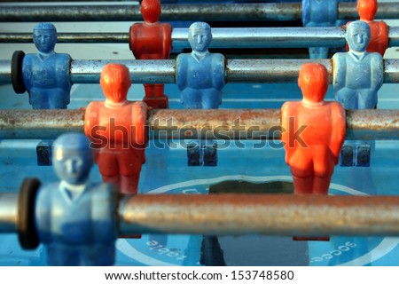 Tabletop foosball game with red and blue figures