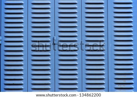 Blue metal blinds at the close window