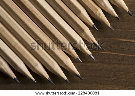 Graphite pencils on a wooden background