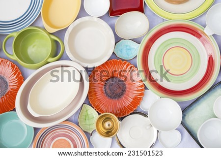 Colorful dishes and utensils on a white cloth